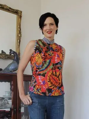 Sleeveless top with a bright tropical floral pattern and striped collar detail