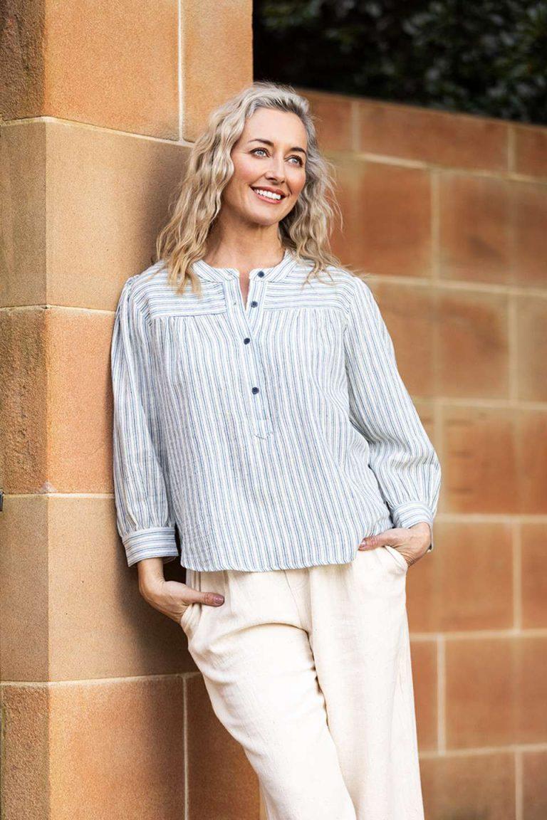 Light blue and white striped blouse with a partial button placket, loose fit, crafted from eco-friendly materials by Colouron Cotton.