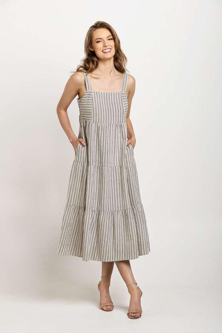 Light gray and white striped tiered dress with wide straps, designed with pockets and a timeless silhouette.