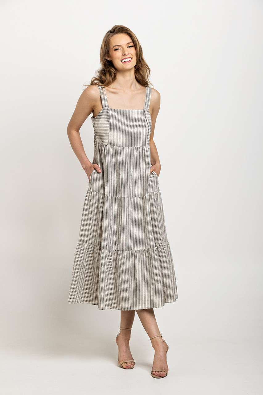 Light gray and white striped tiered dress with wide straps, designed with pockets and a timeless silhouette.