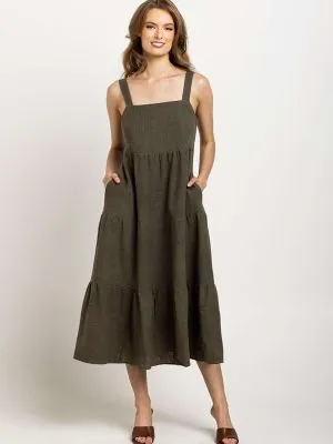 Deep olive tiered dress with a square neckline and pockets, emphasizing Colouron Cotton's slow fashion values.