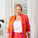 A bold, vibrant orange and pink floral suit with a blazer and matching pants.