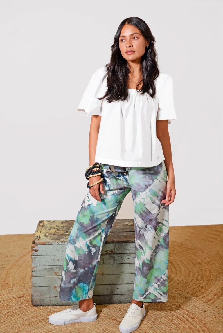 Shibori-dyed pants with a watercolor effect in green and purple hues, created by Lava on sustainable fabric.