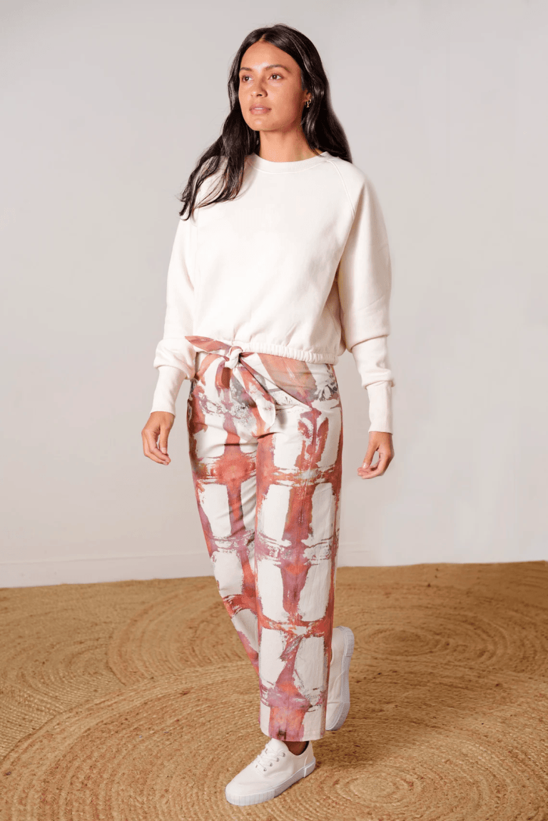 Rust and white grid-patterned pants using ice dyeing techniques by Lava, made from eco-friendly fabric