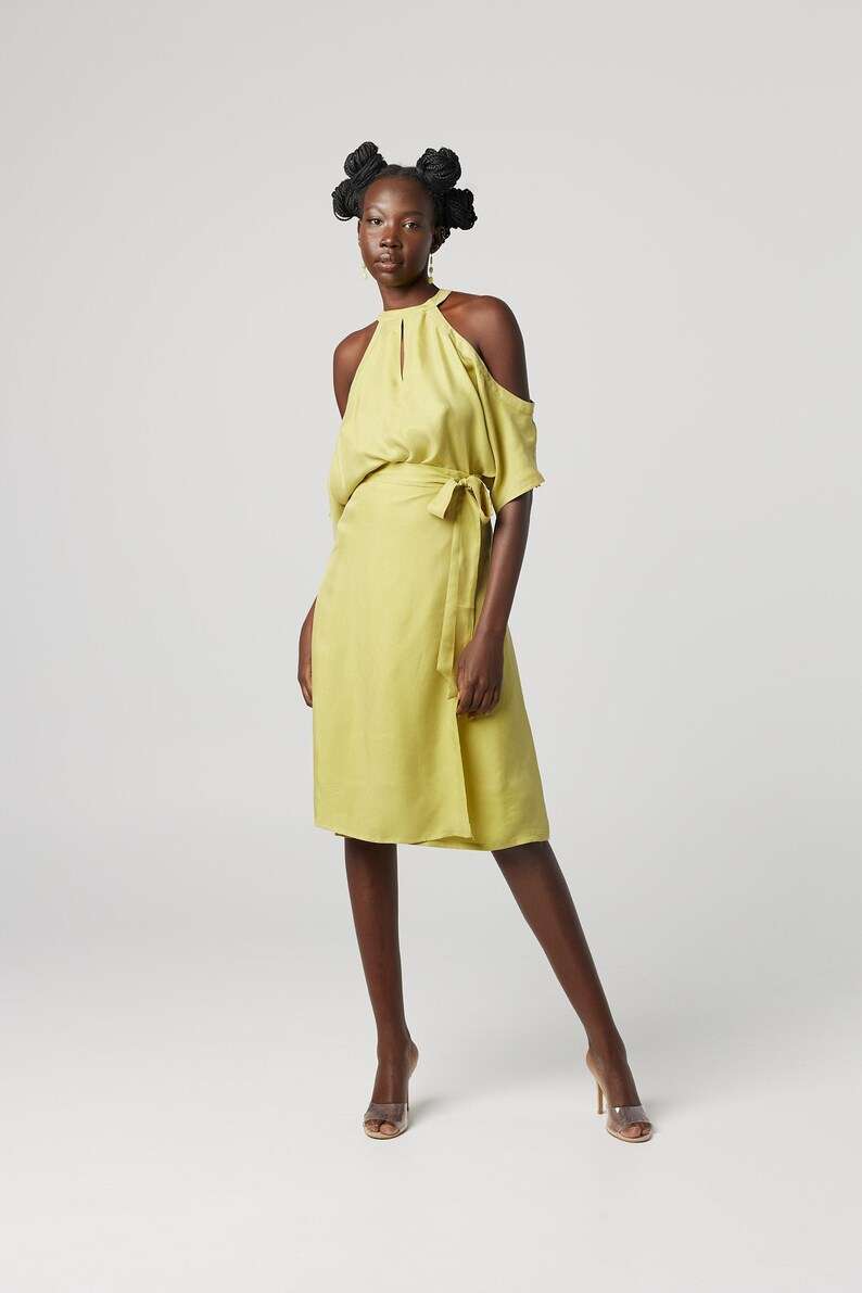 Yellow halter-neck dress: Minimalist cold-shoulder design with a waist tie for sustainable everyday elegance.