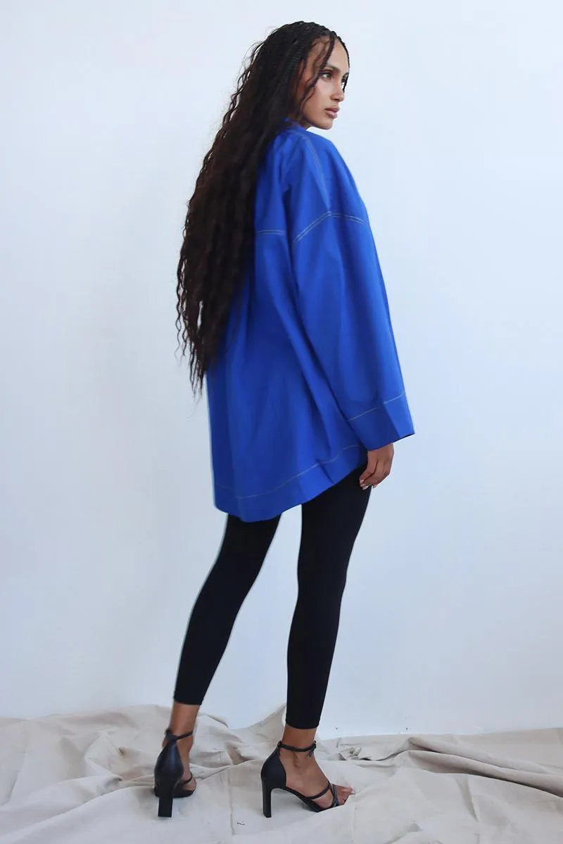 cobalt blue shirt featuring a relaxed drop-shoulder fit and a laid-back camp collar.